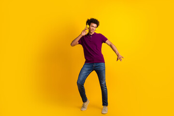 Photo of optimistic cheerful man dj wear trendy polo listen hit melody enjoy playlist isolated on yellow color background