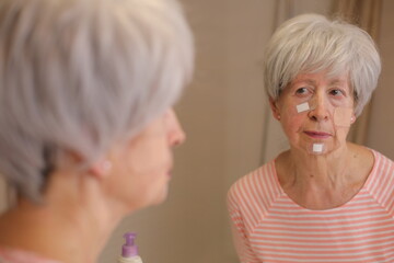 Senior woman with scratches all over her face