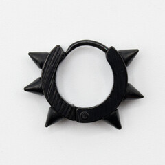Fake hard earring with spikes. Black ear ring. Imitation jewelry. Accessory for rockers, rap,...