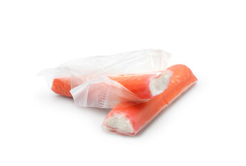Two crab sticks wrapped in plastic transparent packaging film, surimi imitation, isolated on white background © Yana Bo