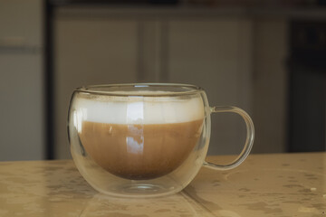 Kyiv, Ukraine - January 30, 2024: On a sunny winter morning, girls in a good mood in home clothes made themselves hot coffee and had breakfast. the girl has warm white pajamas with hearts