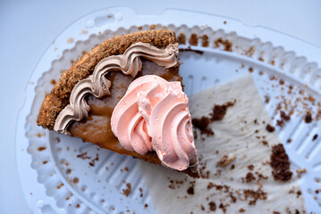 A piece of sweet cake on a white background. Delicious cream cake. A sweet snack.