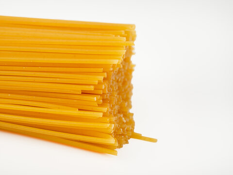 Spaghetti on a white background. Raw spaghetti close-up.
