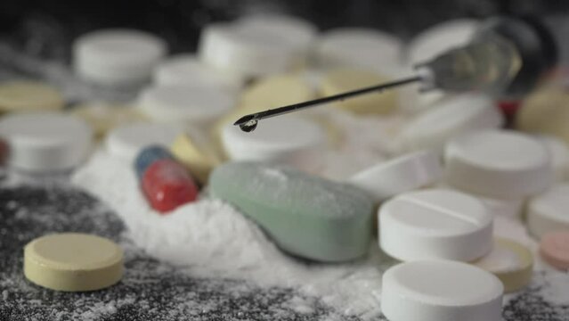 Close-up of a needle with a hanging drop of medicine or drug