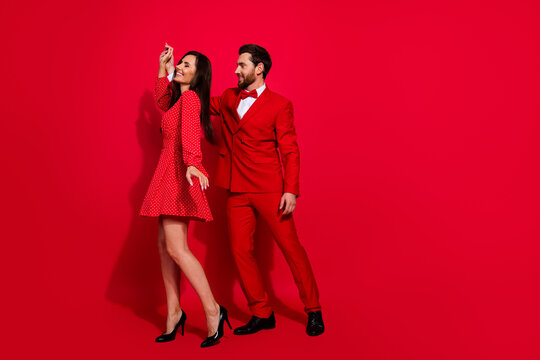 Full length photo of stunning young dance celebrate party valentine day dressed stylish elegant garment isolated on red color background