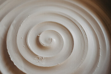 A beautiful spiral, a helical line on a clay surface. Pottery, clay texture decorated with a spiral...