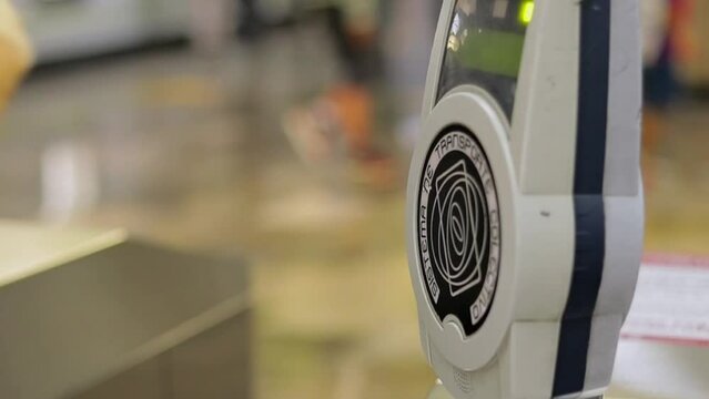 Woman checking the metro turnstile reader with her Mexico City mobility card