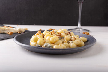 Gnocchi with Gorgonzola and walnuts. Typical Italian food.