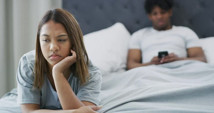 Angry, woman and couple in bedroom after fight from phone, conflict or challenge. Marriage, stress or person frustrated with partner cheating online in affair or depressed from divorce and break up