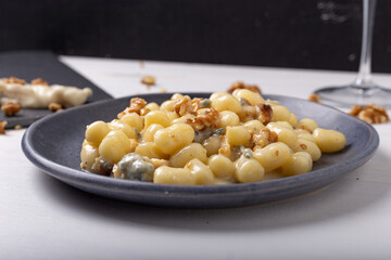Gnocchi with Gorgonzola and walnuts. Typical Italian food.