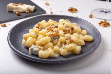 Gnocchi with Gorgonzola and walnuts. Typical Italian food.