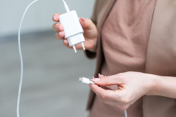 woman holding Electrical adapter. hand holding charger
