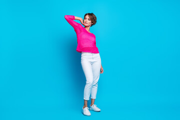 Fototapeta na wymiar Full length photo of cheerful lovely woman wear knitted neon shirt looking empty space isolated blue color background