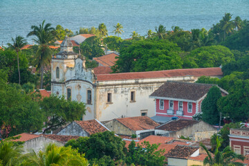 Ancient coastal church surrounded by lush tropical forest in the old colonial town of Olinda,...
