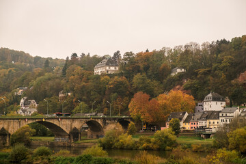 Autumn landscape with colorful trees and a bridge over the river Moselle in Trier, Germany
