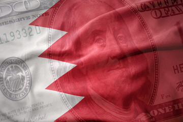 waving national flag of bahrain on a american dollar money background. finance concept.