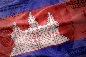 waving national flag of cambodia on a american dollar money background. finance concept.