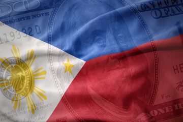 waving national flag of philippines on a american dollar money background. finance concept.