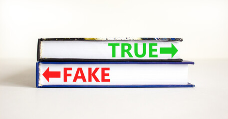 True or fake symbol. Concept word True or Fake on beautiful books. Beautiful white table white background. Business and true or fake concept. Copy space.