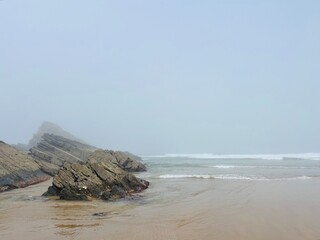 Fototapeta na wymiar foggy ocean coast, fog at the ocean beach