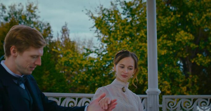 beautiful woman in retro clothing and her boyfriend dancing waltz in park, 19th century, 4K, Prores