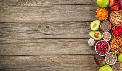 Set of vegetables, seeds and fruits on a wooden background. Detox and clean diet concept. top view....