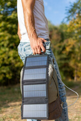 Guy charging phone with solar panel