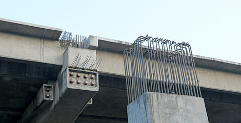 TMT bars or rebars jutting out of unfinished pillars and beams at an ongoing flyover project