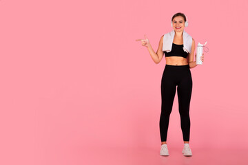 Check This. Sporty Young Woman Pointing At Copy Space Over Pink Background