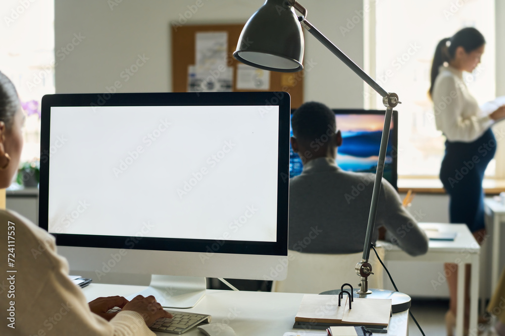 Aufkleber Blank screen of desktop computer standing on workplace of office manager pressing keys of keyboard during network