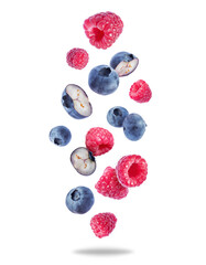Group of ripe juicy blueberries and raspberries close up in the air on a transparent background