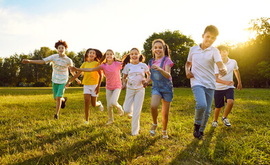 Happy, joyful, carefree kids playing together in summer. Children enjoying free time, playing and...