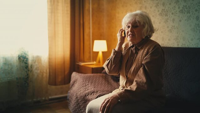 Displeased senior woman calling municipal call center line, filing a complaint