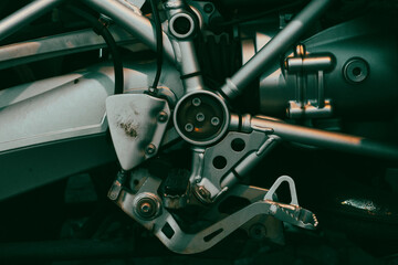 Close up motorcycle pedal brake engine part. Motorbike close up pedal part brake with bolts. Right...