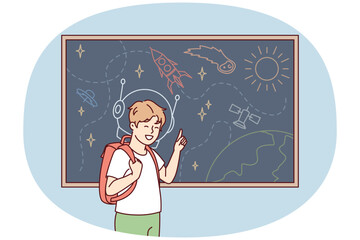Joyful boy with backpack behind back stands near blackboard depicting universe with spaceships and planets. Schoolboy is fond of astronomy with drawings of UFOs and satellite ships. Flat vector image