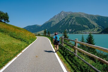 Fototapeta na wymiar View of Lake Resia with its cycle pedestrian path in South Tyrol
