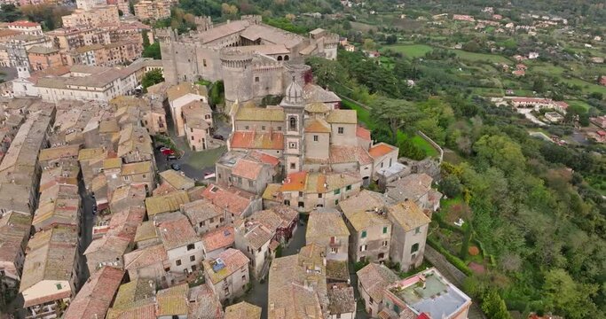 Aerial view of the castle in Bracciano Italy. Tourist town with a castle with high walls and watchtowers in a beautiful mountain landscape in Europe. High quality 4k footage
