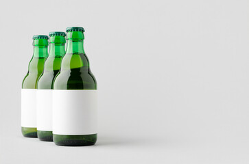 Green steinie beer bottle mockup with blank label.