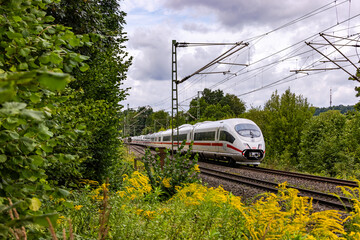 An Intercity Express train between nature in the countryside and technology