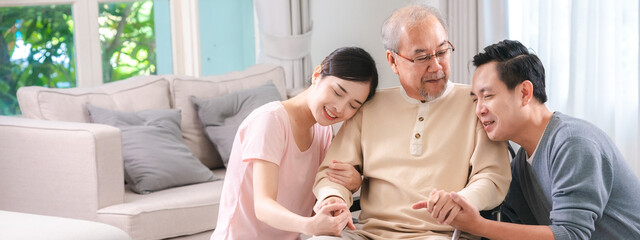Gentle daughter and son are taking care and support help their retired and elderly father or dad on...