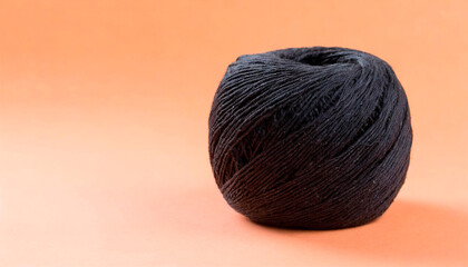 Partially rolled black colored sewing wool ball on peach background. Connections between points, the concept of innovative and computer work. Today's game of Connections. Connections Hints.Copy Space.