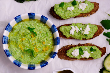 Green pea dip with feta and crostini. top view .