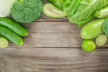 raw healthy food clean eating vegetables source. green vegetables on a wooden background, top view....