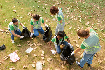 Group of eco volunteers collecting garbage on college campus