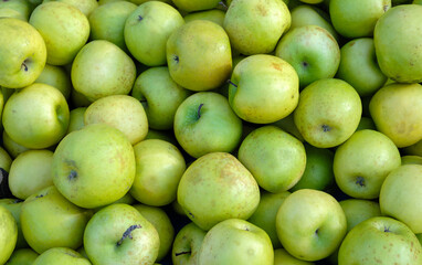 Background of green apples on sale at local market
