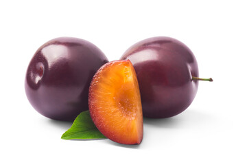 Juicy purple Plum fruits with cut in half and green leaf isolated on white background.