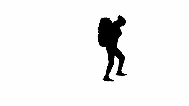 Black silhouette of a male traveler taking photos on a mobile phone during a hike. A male traveler stands on white isolated background. Concept of travel, active rest, hiking. Rear view.