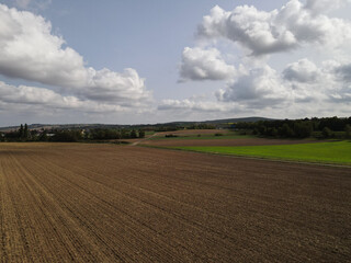 Fototapeta premium Aerial view of a plowed agriculture field with soil