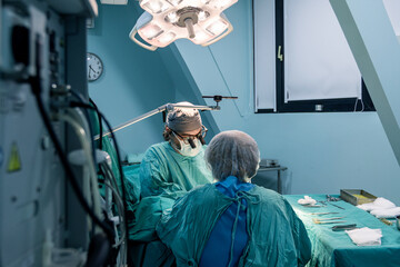 Skilled surgeon performs a precise operation in a sterile operating room.	