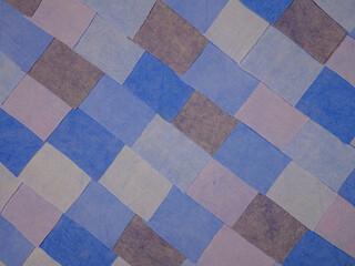 Handmade background in patchwork style with cotton fabric elements in blue tones 